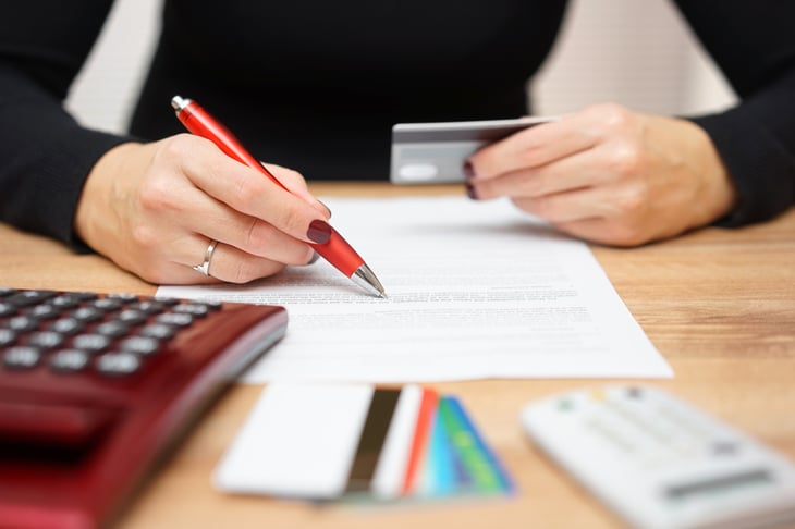 Woman fill out paperwork for credit cards