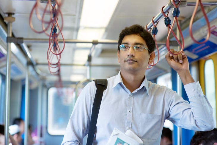 A man rides a train to work