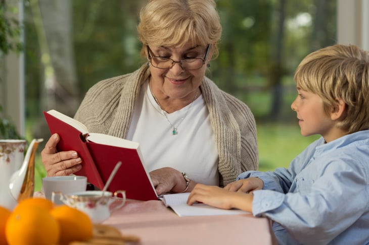 An older woman tutors a student