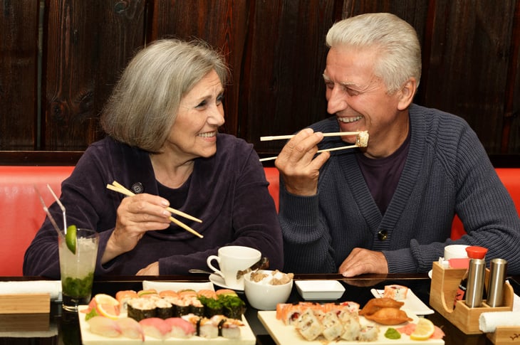 Senior couple eating sushi at a restaurant