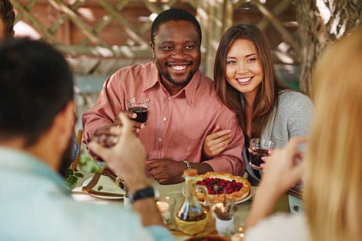 Couple drinking red wine with friends