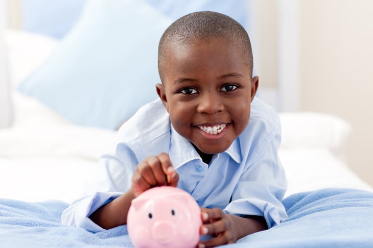 Little boy with piggy bank