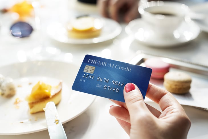 Woman using a credit card at a restaurant