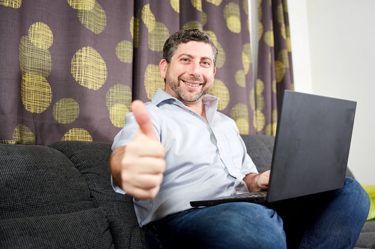 Man working remotely gives a thumbs up