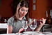 Woman looks at shockingly high wine prices