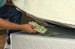 Man hiding cash under a mattress